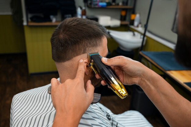 Side view man getting a haircut