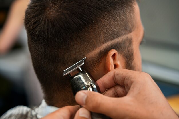 Side view man getting a haircut