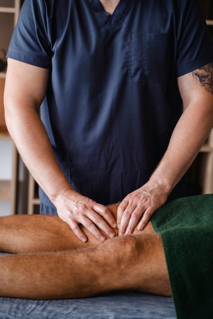 Side view man getting professional massage