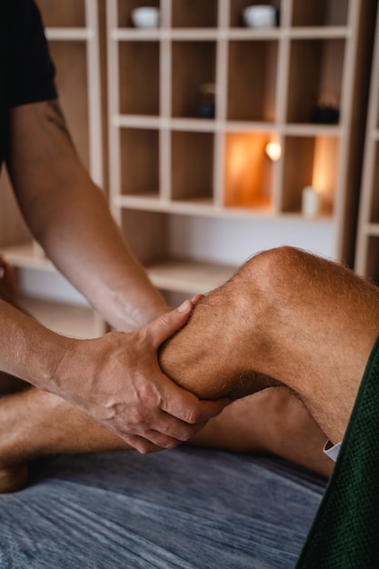 Side view man getting professional massage