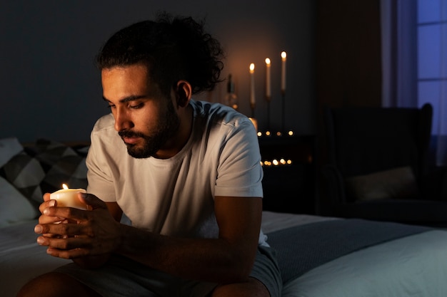 Side view man holding candle