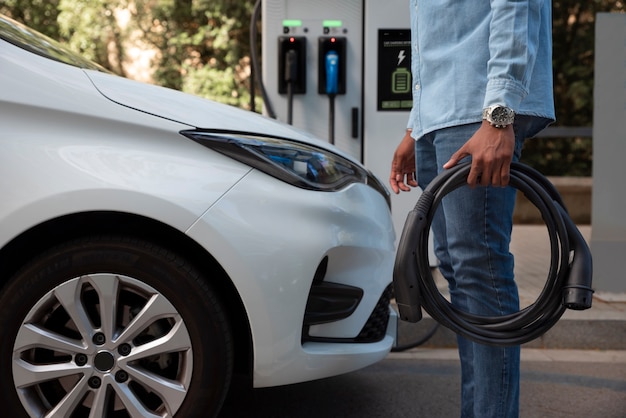 Side view man holding car cable