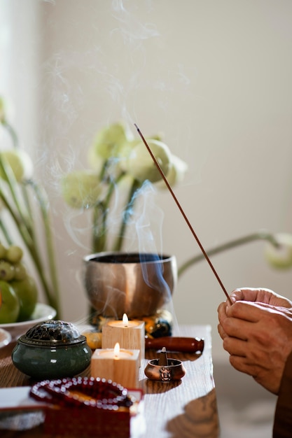 Side view of man holding incense stick