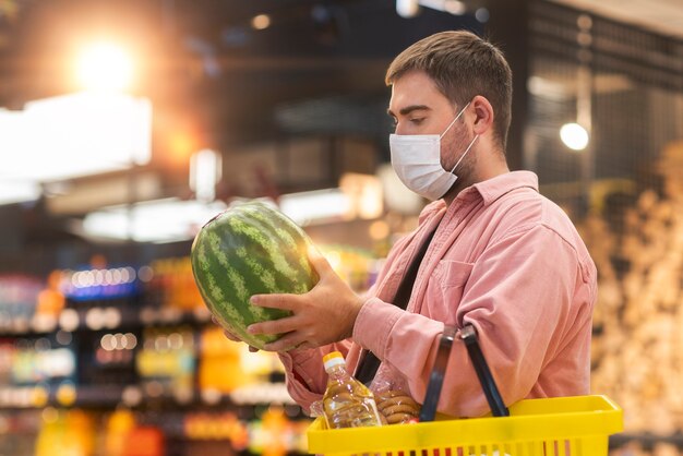 Side view man holding watermelon