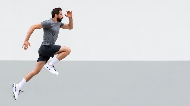 Side view man jumping outdoors