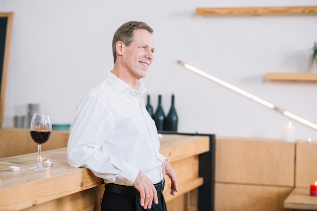 Free photo side view of man leaning on table