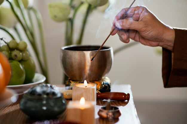 Side view of man lighting incense stick