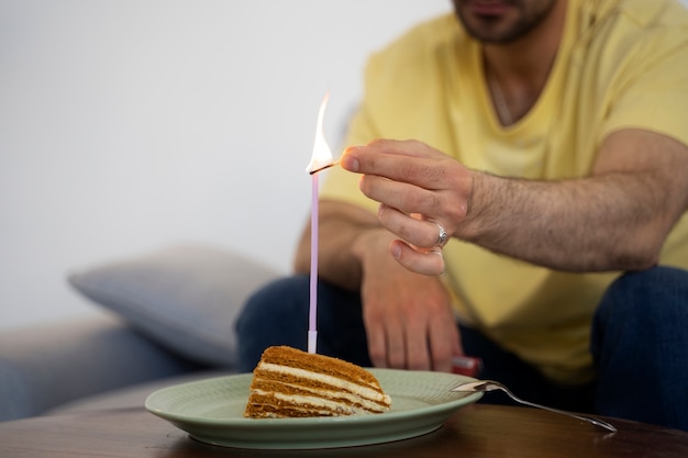 Side view man lighting up candle