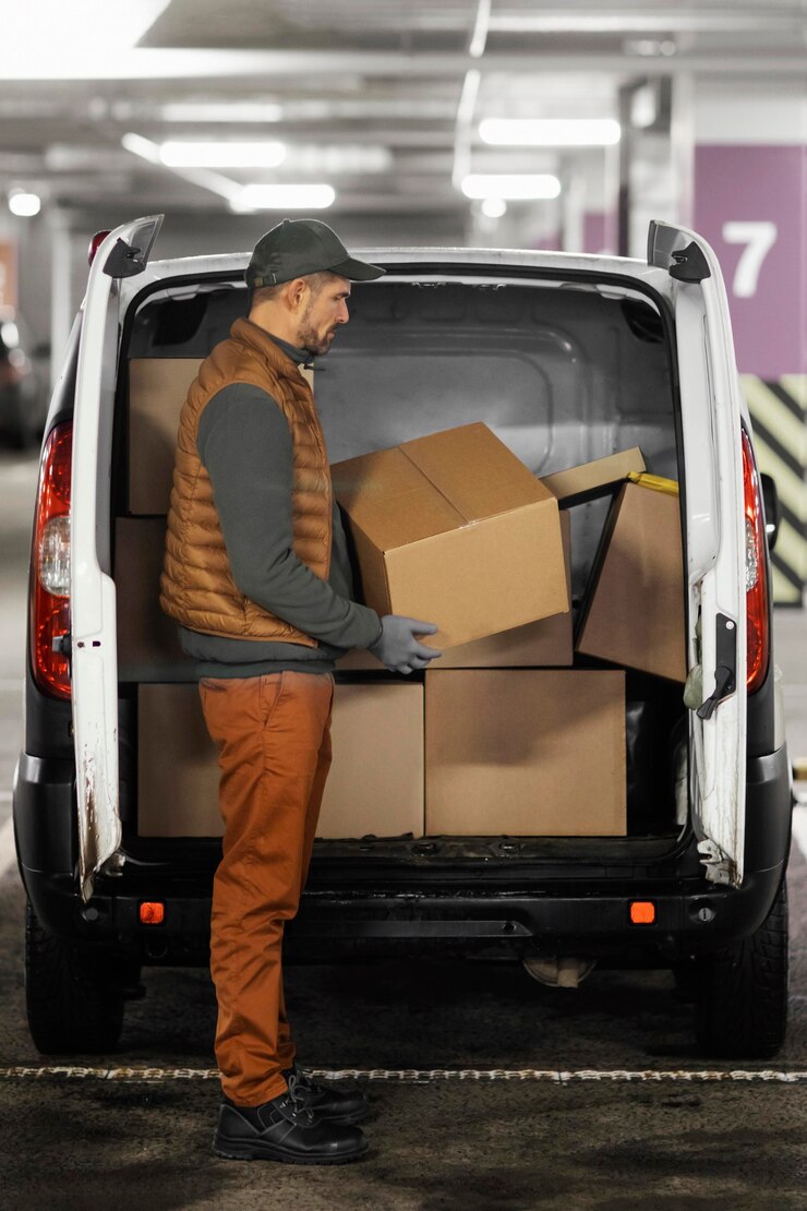 Free Photo side view man loading car with packages