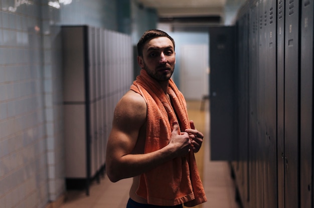 Side view man at locker room after swimming