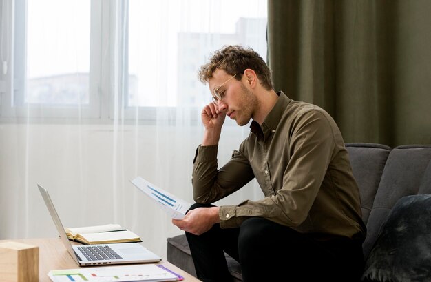 Side view man looking at infographics