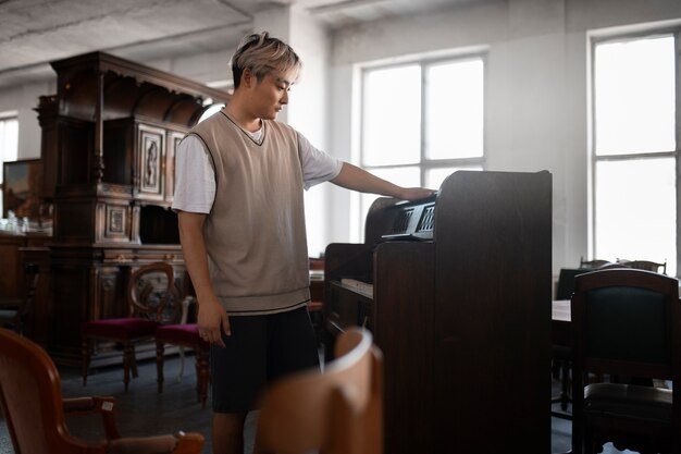 Side view man looking at piano