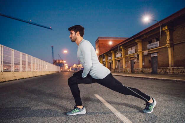 Side view man lunging in evening