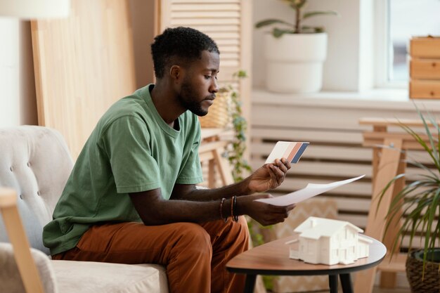 Side view of man making a plan to redecorate house