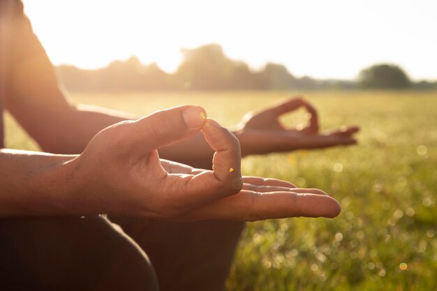 Side view of man meditating outdoors