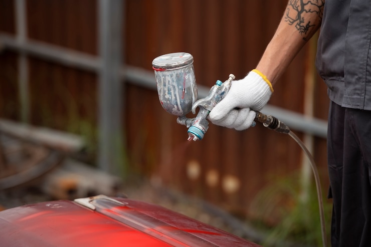 Free Photo side view man painting car door