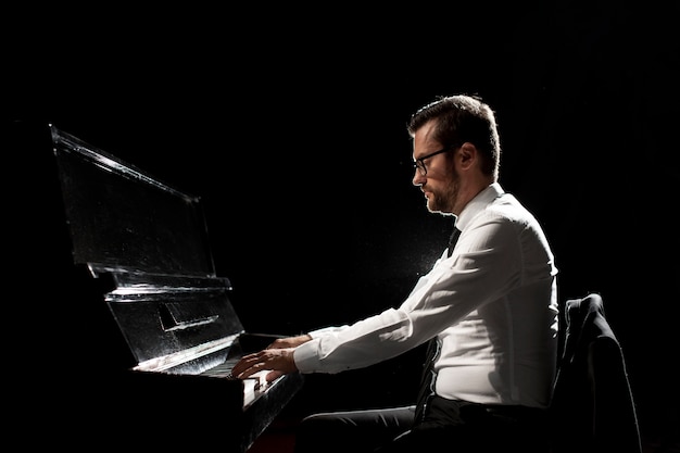 Side view of man playing the piano