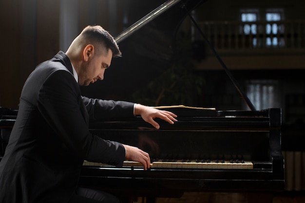 Side view man playing piano