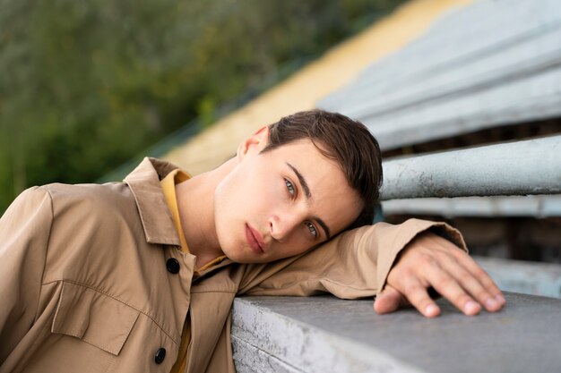 Side view man posing  in grandstands