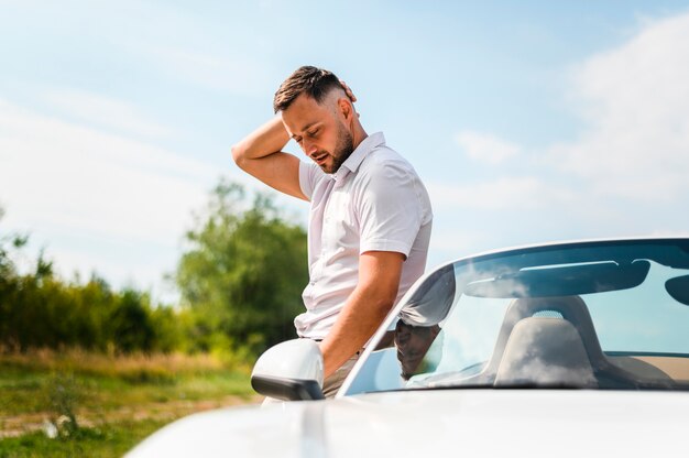 Side view of man posing outdoors