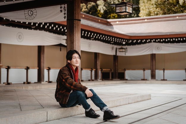 Free photo side view of man posing on stairs outdoors