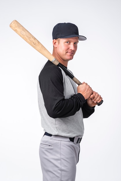 Side view of man posing with baseball bat