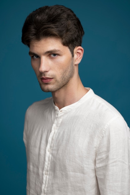 Side view man posing with blue background