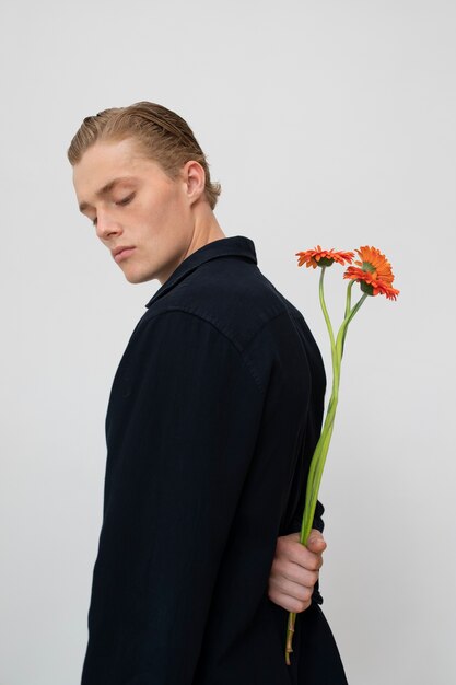 Side view man posing with flowers