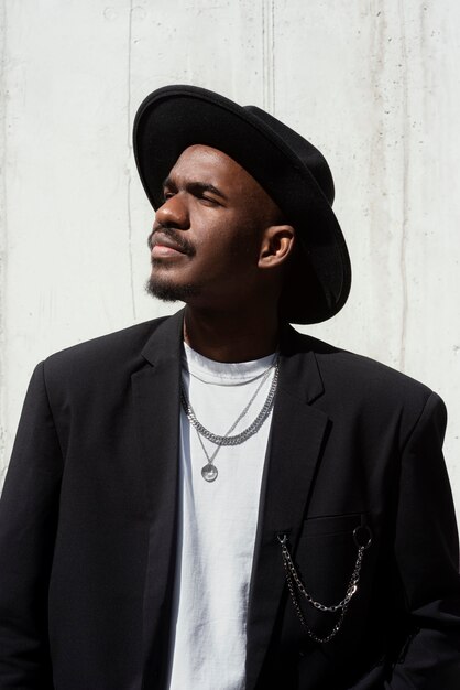 Side view man posing with hat