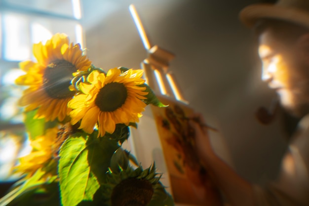 Foto gratuita uomo di vista laterale che posa con i girasoli