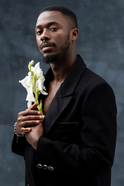 Side view man posing with white flower