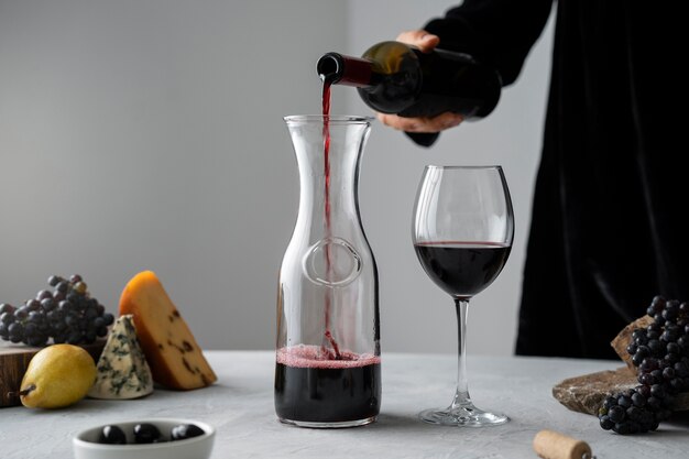 Side view man pouring wine in carafe