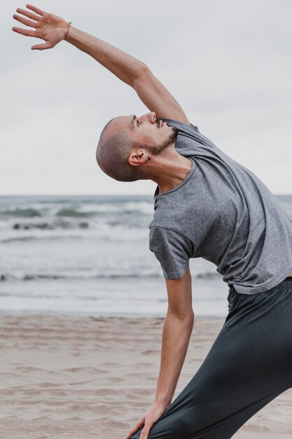 Side view of man practicing yoga