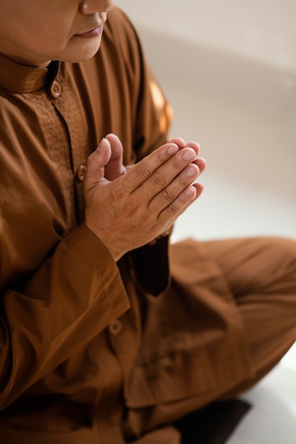 Free photo side view of man praying