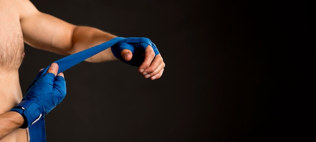 Side view of man preparing for boxing