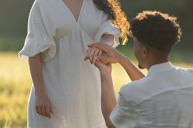 Side view man proposing with ring