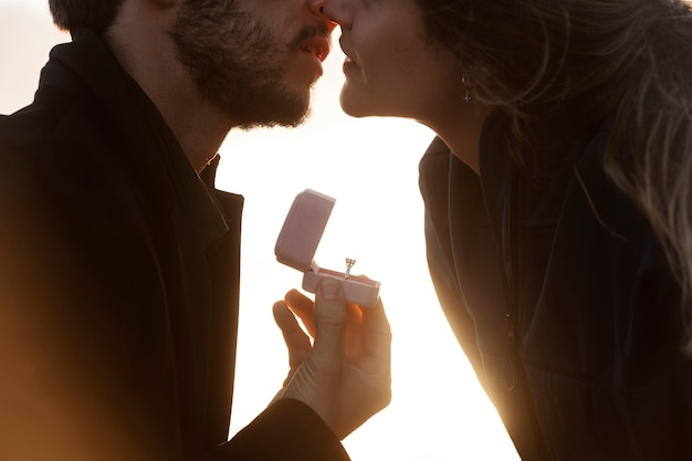 Side view man proposing to woman