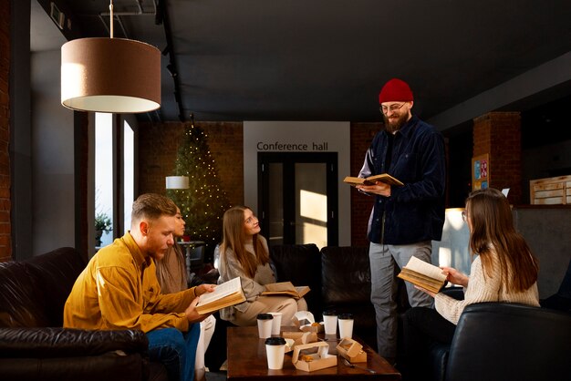 Free photo side view man reading at book club