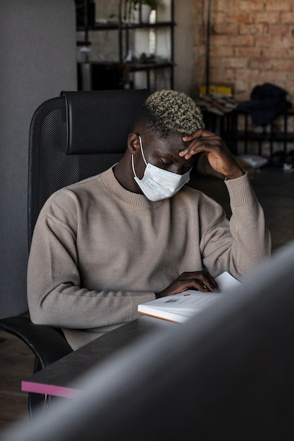 Side view man reading indoors