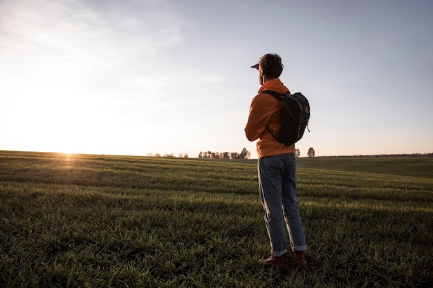 Side view of man on a road trip admiring the view