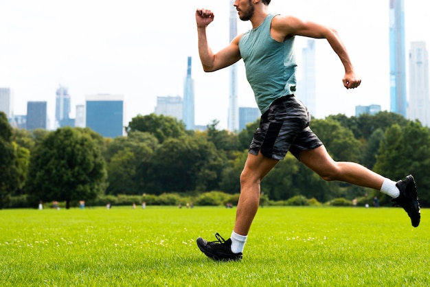 Side view of man running on grass