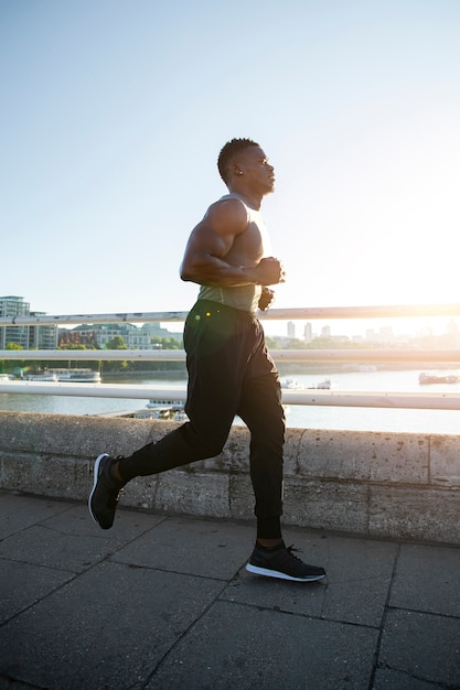 Free photo side view man running outdoors