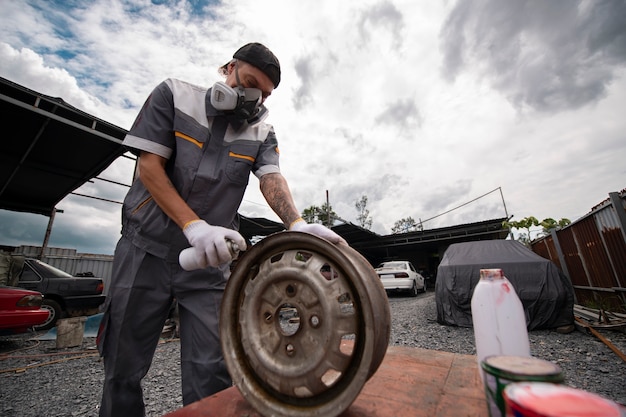 Side view man spraying powder paint