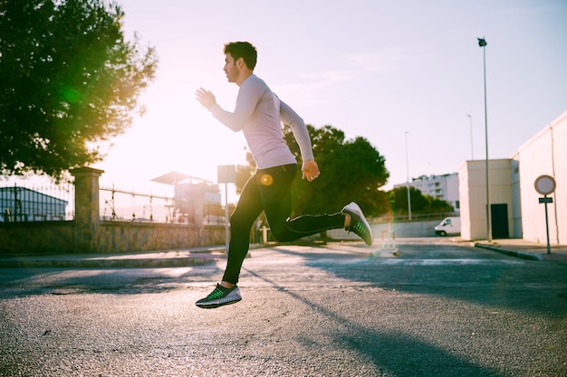 Side view man sprinting on street