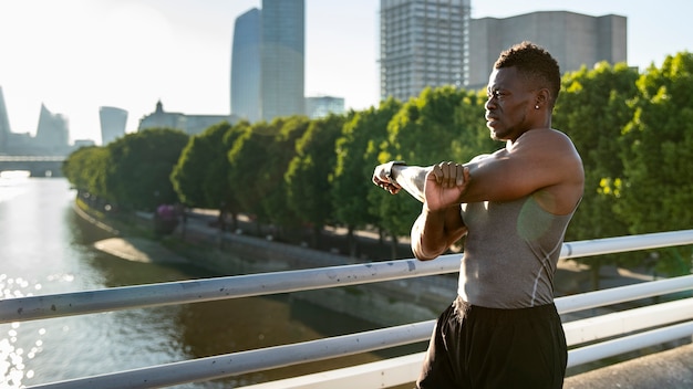 Free photo side view man stretching arm