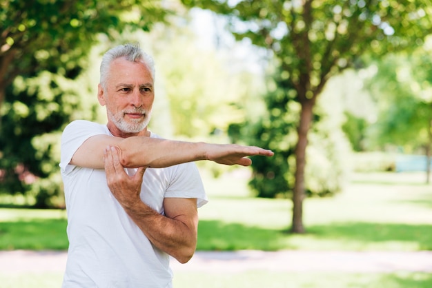 Side view man stretching his arm