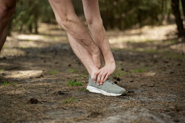 Side view man stretching leg