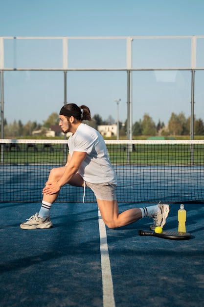 Side view man stretching outdoors