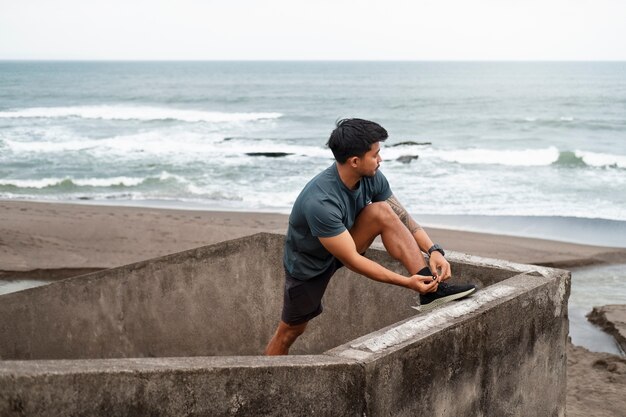 Side view man stretching outdoors