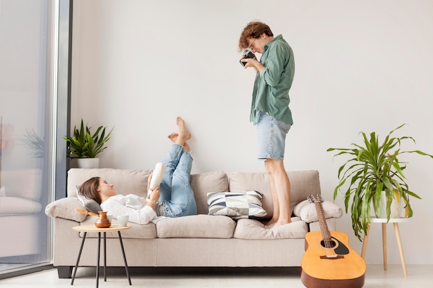 Side view man taking photos of woman